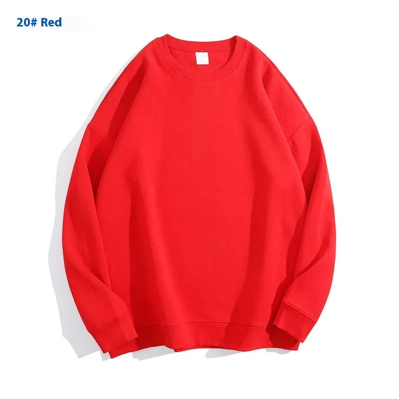 A loose-fitting, off-shoulder cotton sweater in a solid colour with long sleeves and a round neck.