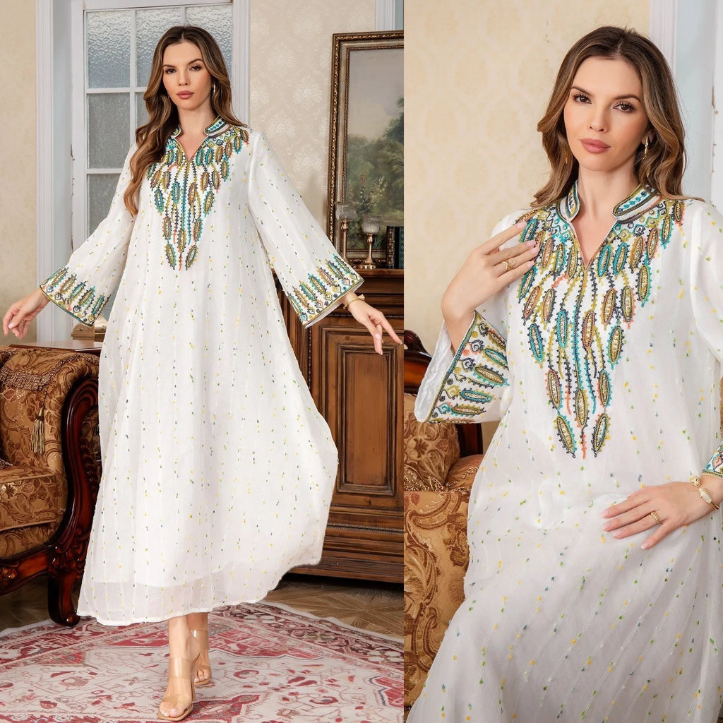 White long sleeve long skirt Arabic robe for women on a hanger.