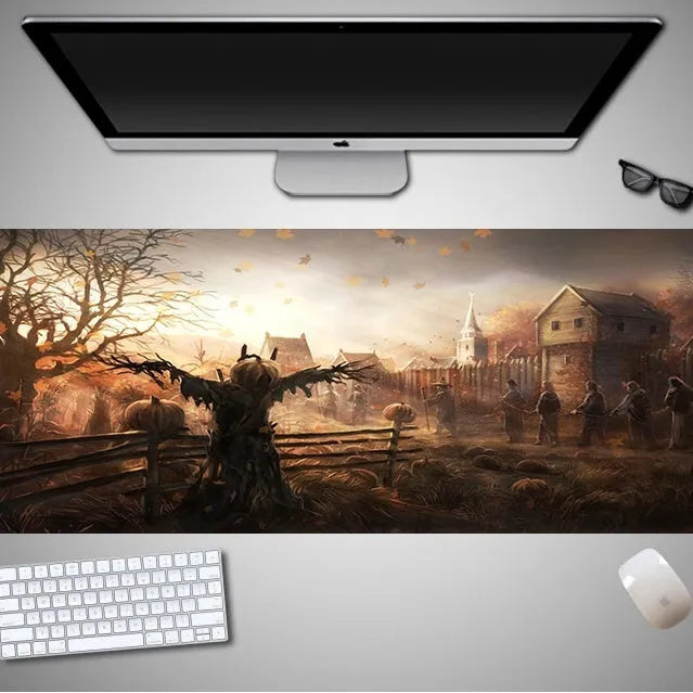 Oversized black Halloween-themed mouse pad with spooky artwork on a desk next to a gaming mouse.