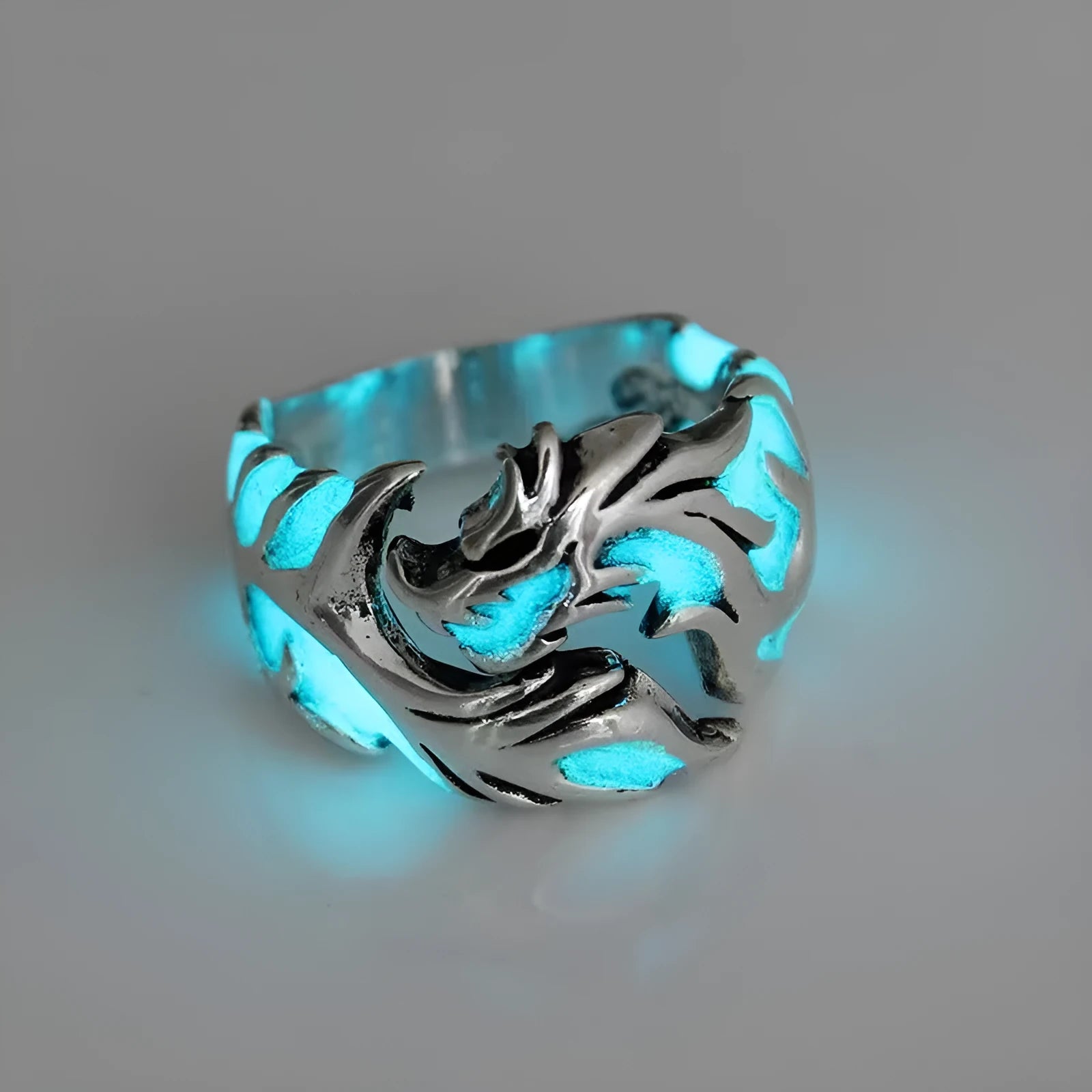 Close-up of an adjustable Chinese dragon pattern ring in antique silver, blue, and green colours.