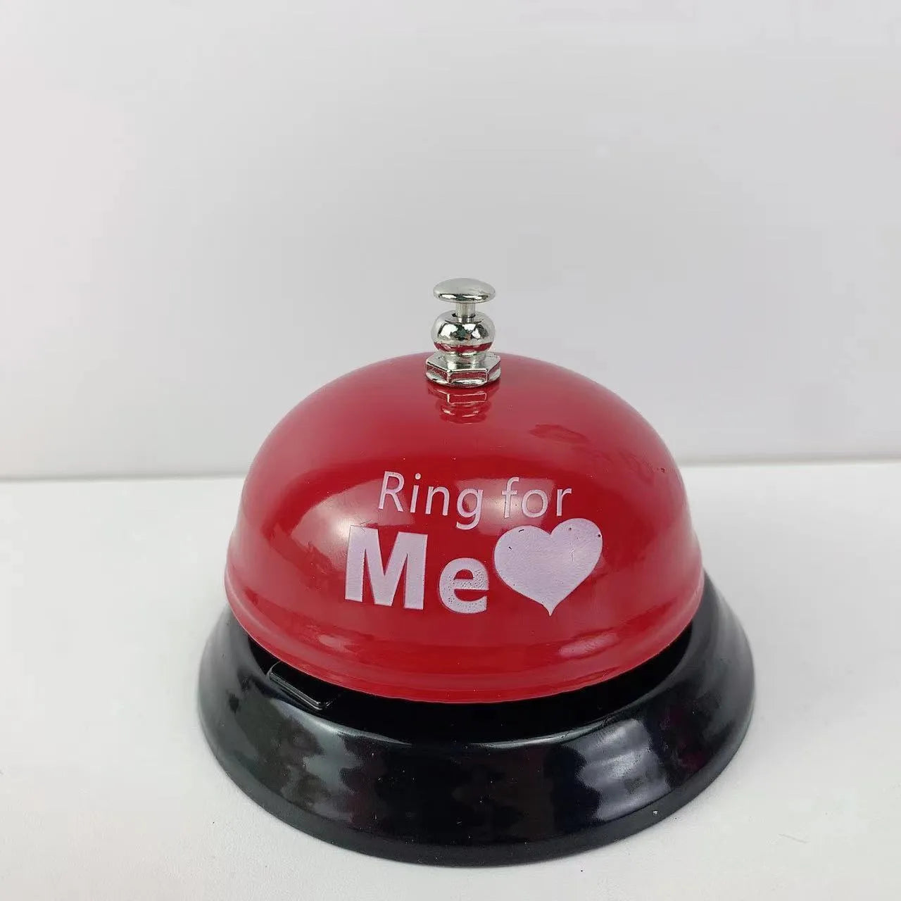 A multi-colour iron hand bell for games, classrooms, or restaurant service.