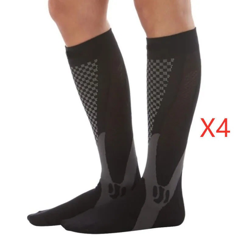 Graduated compression socks for men and women in black, shown laid flat.