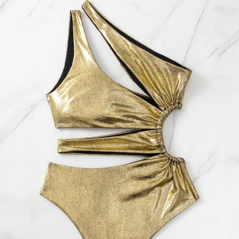 Women's gold backless one-piece swimsuit with sleeveless design on mannequin
