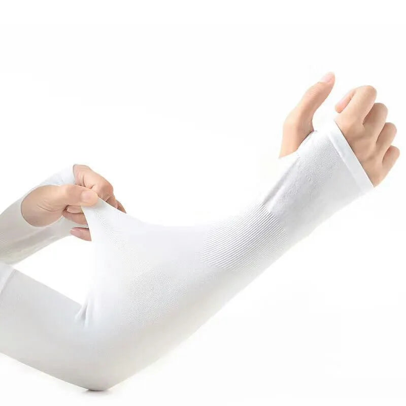 A person wearing a grey sun protection driving sleeve on their forearm, showing the open finger design.