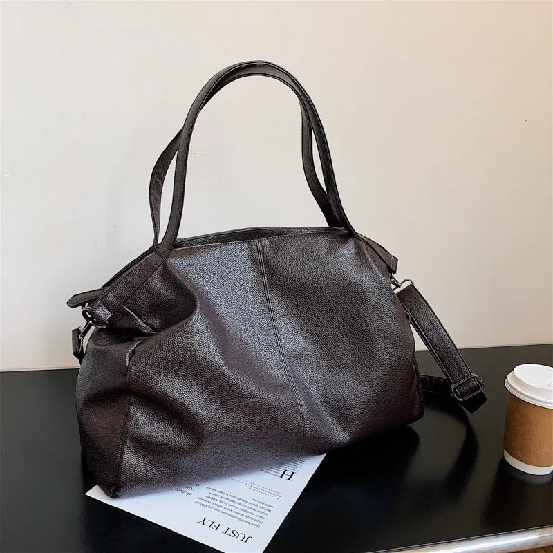 Large soft black PU messenger tote bag with car suture detailing and a long shoulder strap