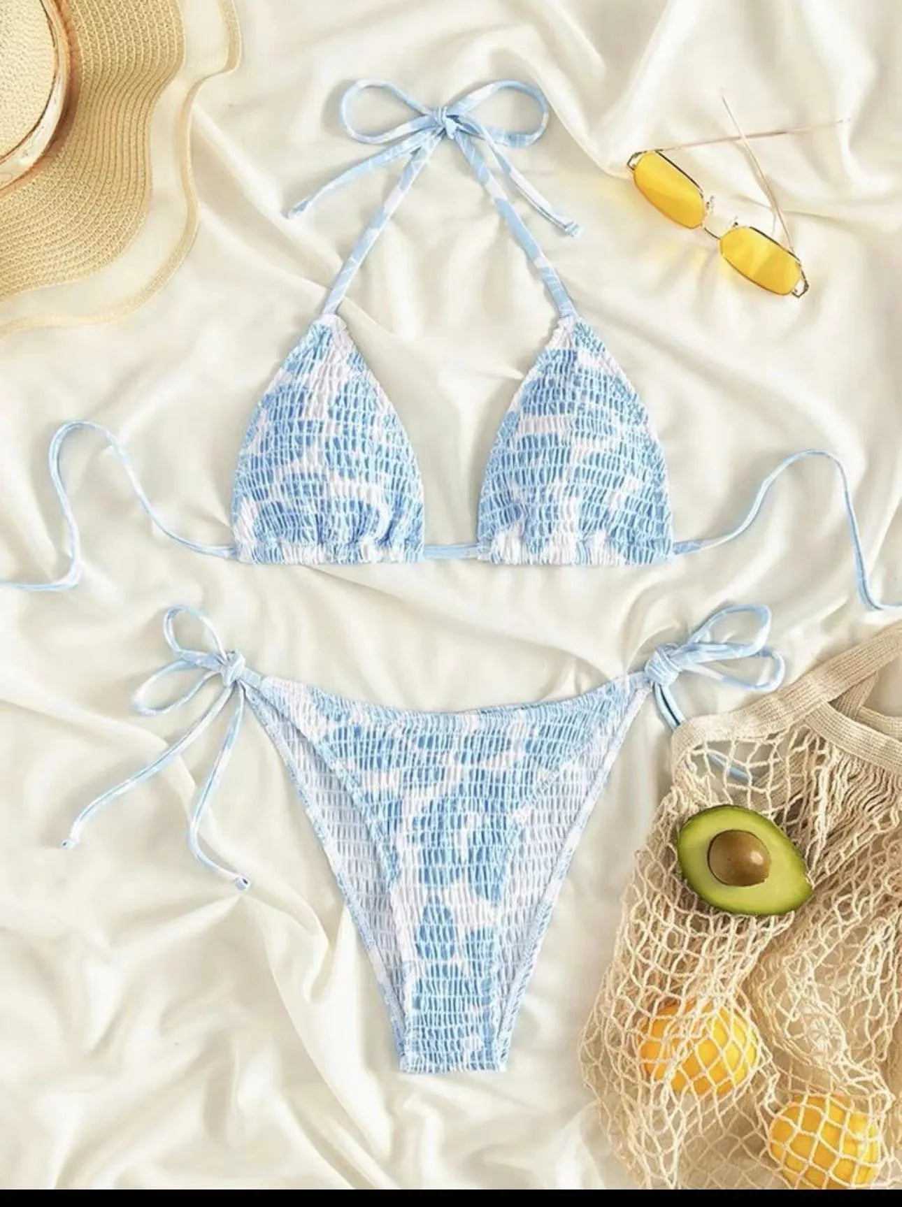 Women's floral halter neck swimsuit briefs in light blue on a mannequin