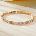 Unisex gold electroplated double-row diamond zirconia tennis chain bracelet on white background