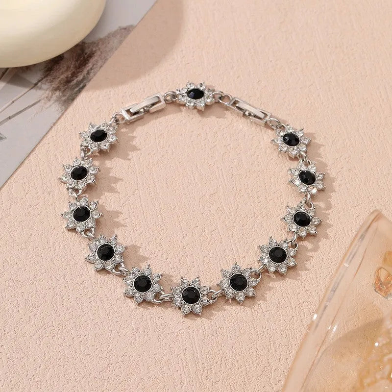 Floral zinc alloy bracelet with electroplated gold or silver finish and gemstone colour variants