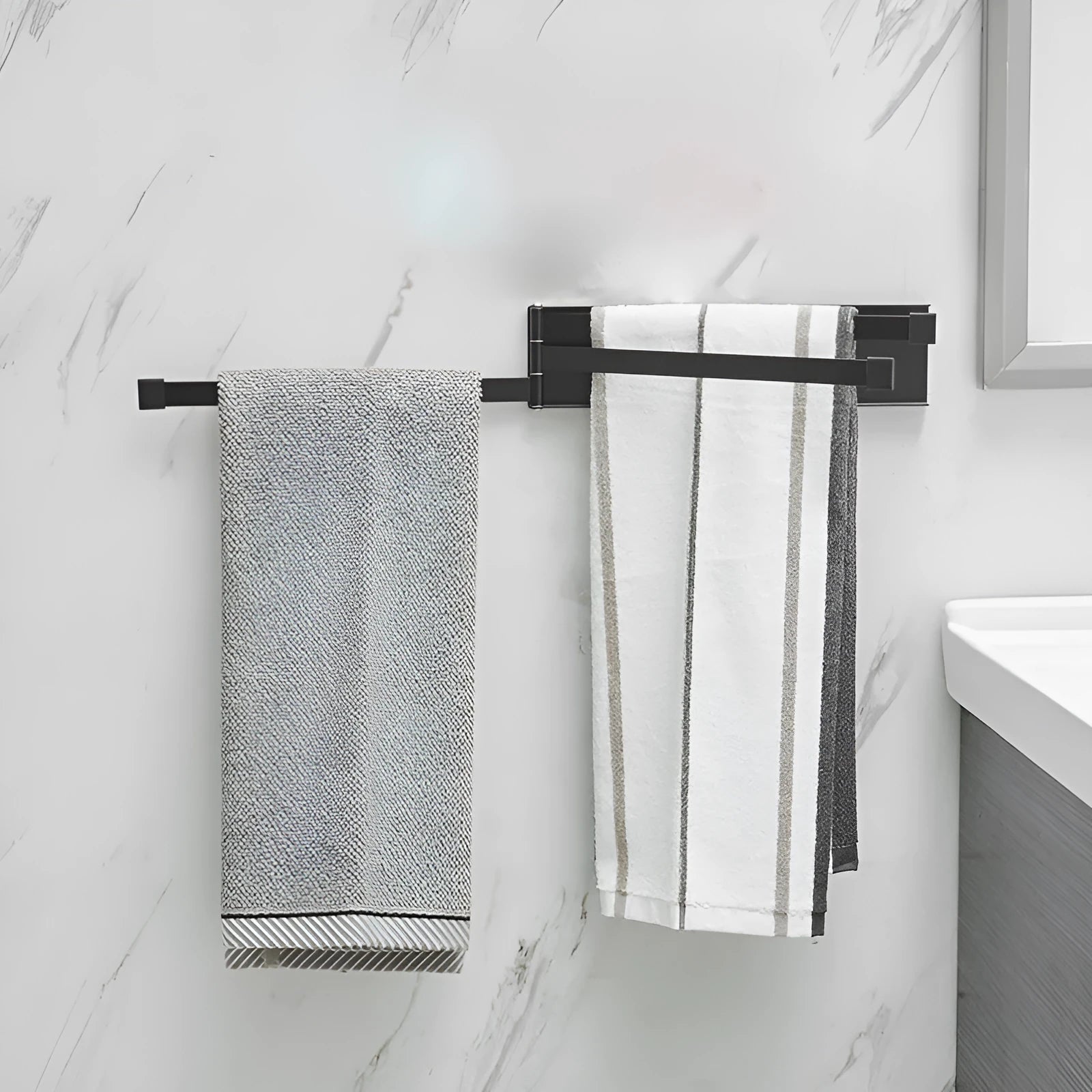 Nordic folding towel bar in black mounted on bathroom wall with towels hanging