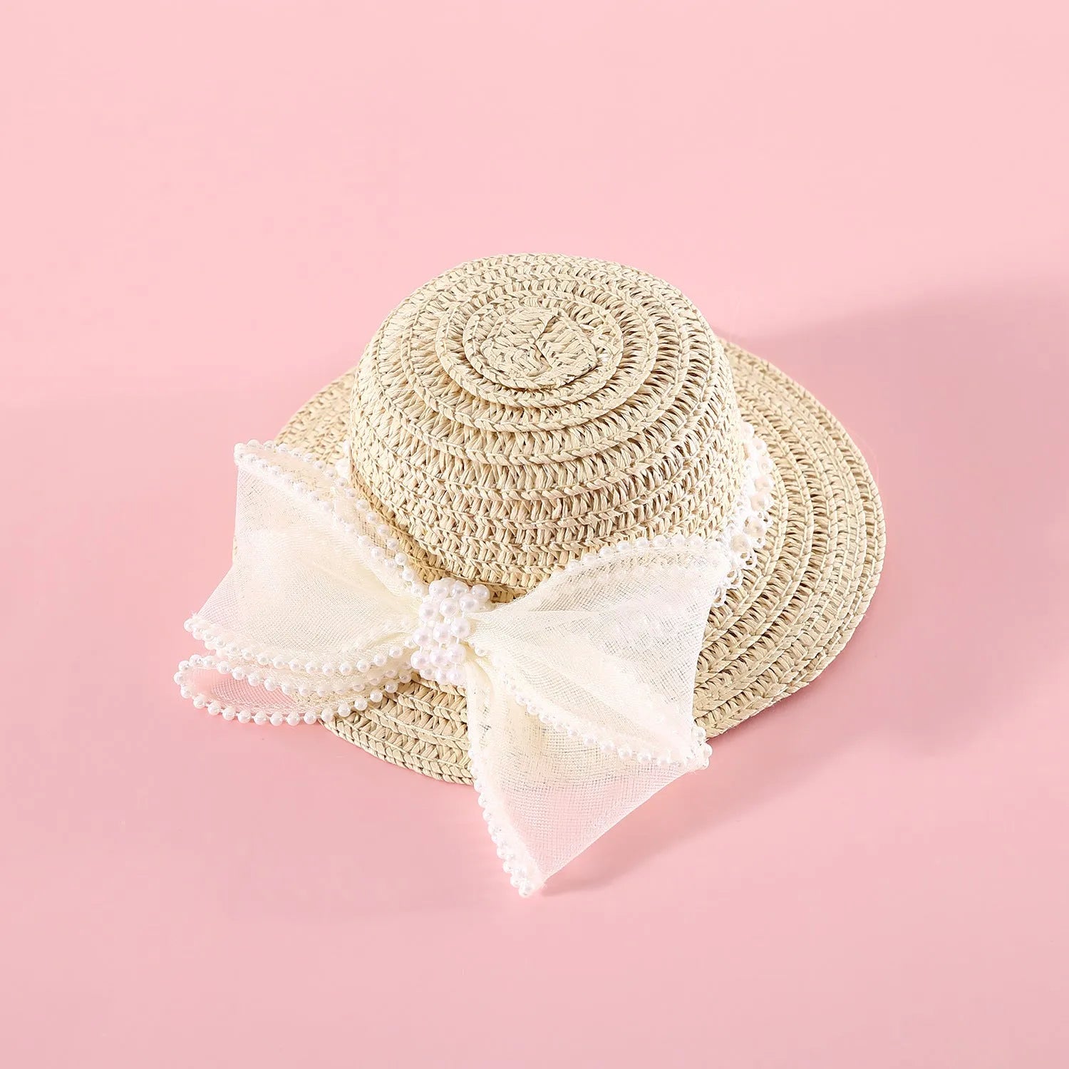 Pet cat wearing princess-style straw hat with woven pearl bow decoration in lafite leaves material