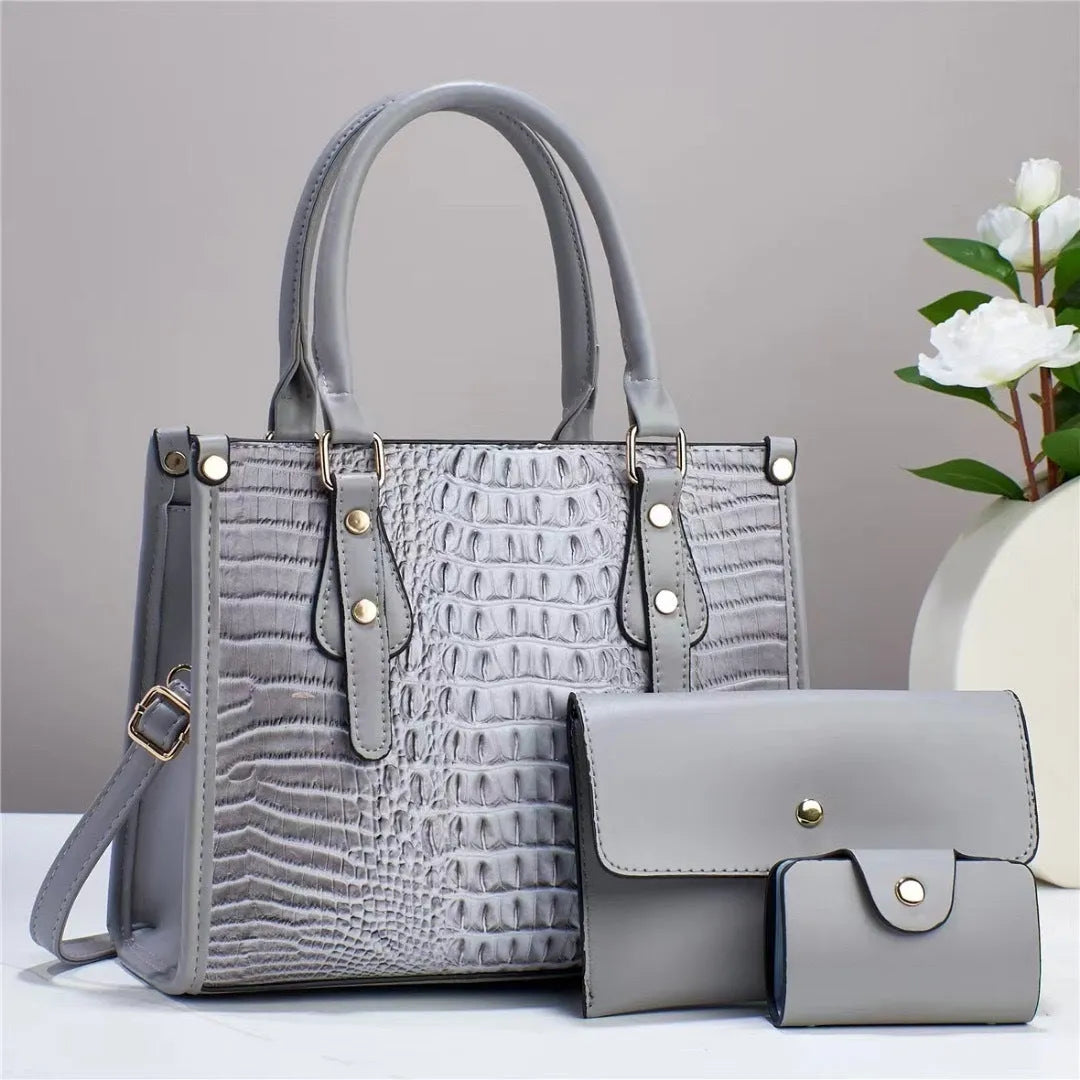 Women's textured PU leather three-piece travel bag set showing crossbody bag, wallet and card holder in coordinated colour
