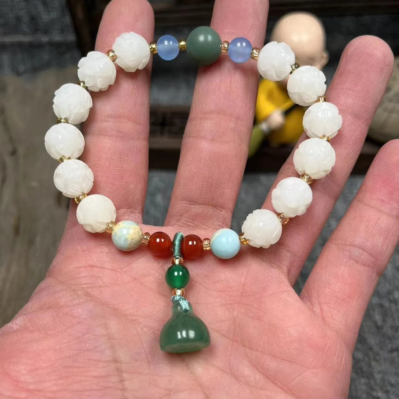 Carved pumpkin and lotus bead bracelet made from Bodhi root with white jade and aventurine details.