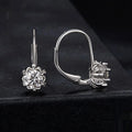 A pair of sterling silver flower bud design ear clips with white gold plating and moissanite stones.
