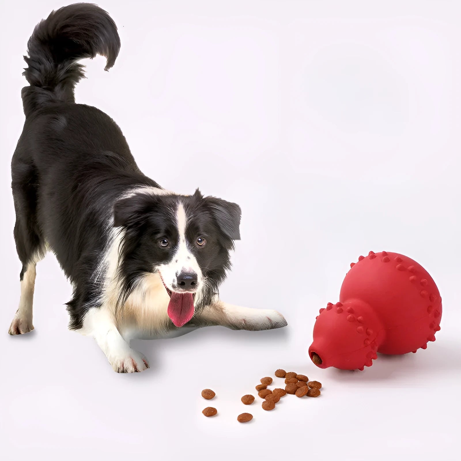 Natural rubber pet toy resistant to biting and grinding, treat dispensing ball in red, 11.3 by 8.5 cm