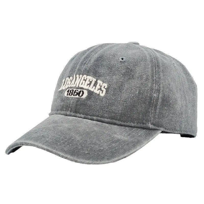 Retro personalised distressed embroidered peaked cap in beige colour with adjustable strap and conical crown.