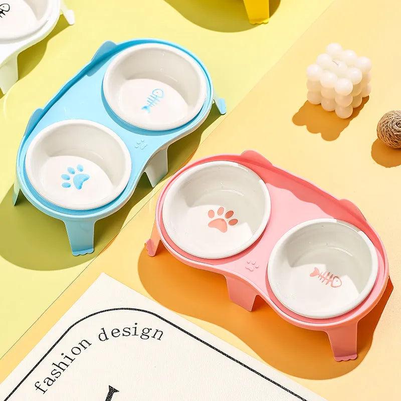 Ceramic cat food and water bowl set on a white tilted ABS stand, shown in blue colour
