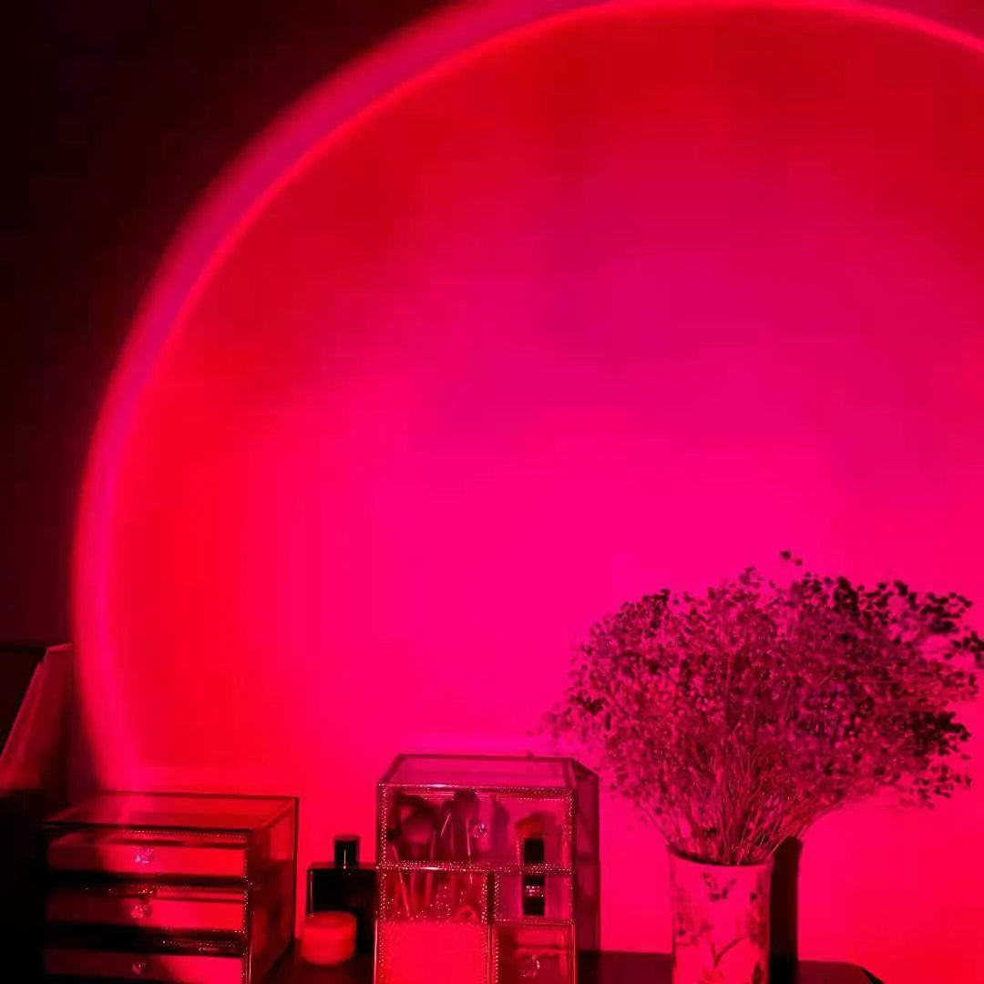 Sunset red coloured USB rechargeable projection lamp showing rainbow light projection