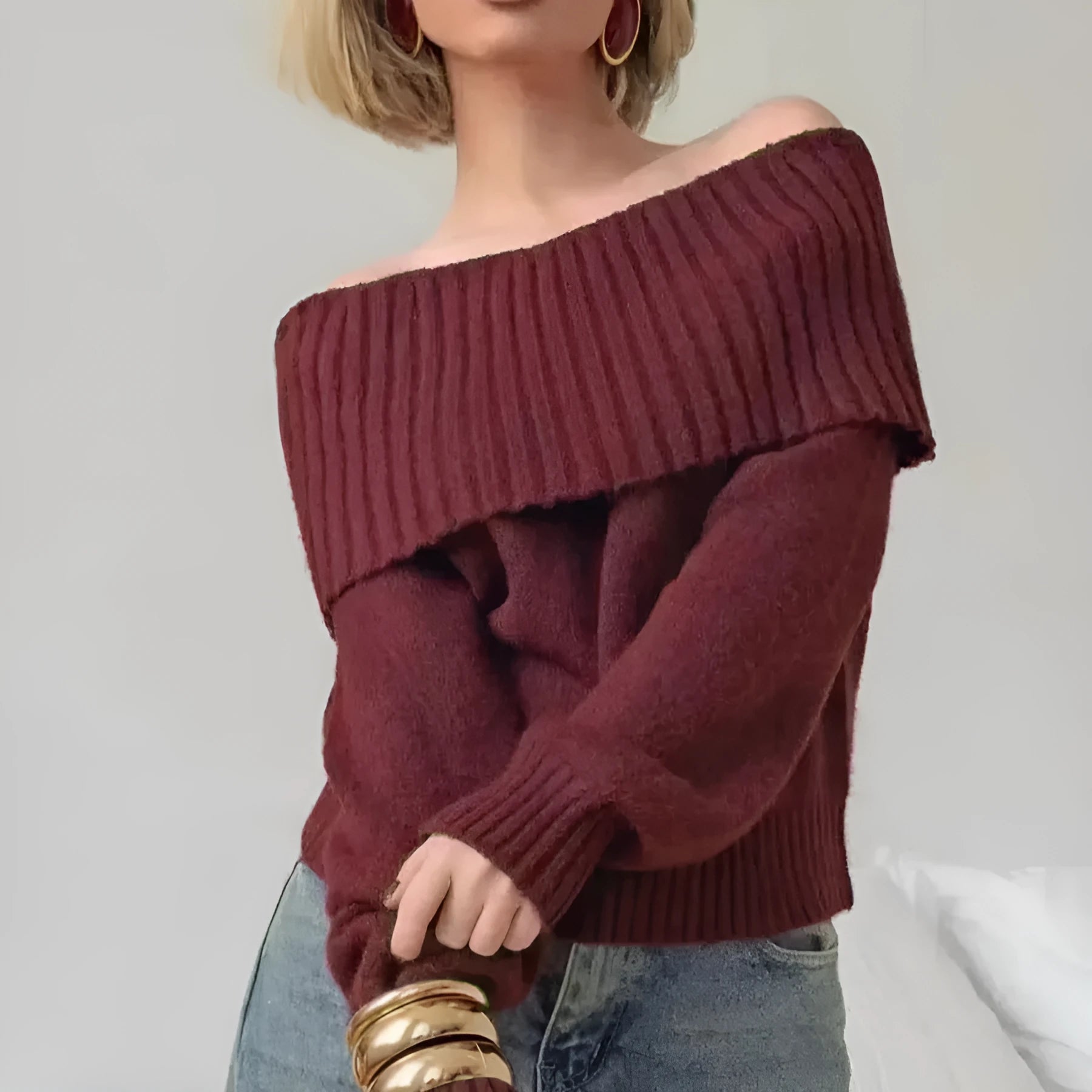 Grey off-the-shoulder strapless sweater with a 3D textured pattern and regular sleeves.
