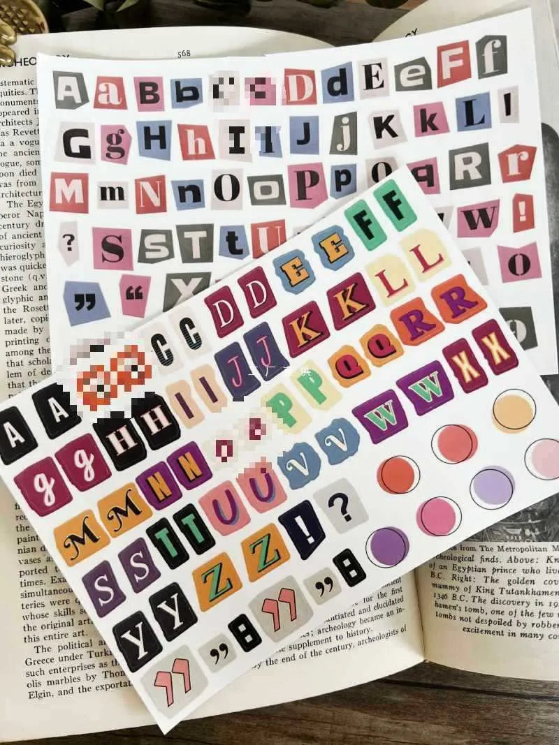 Set of printed cute style decoration stickers showing English letters, numbers, and weekly words on sheets.