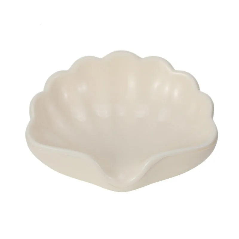 Plastic shell-shaped soap dish in pearl white or pink colour for bathroom organisation