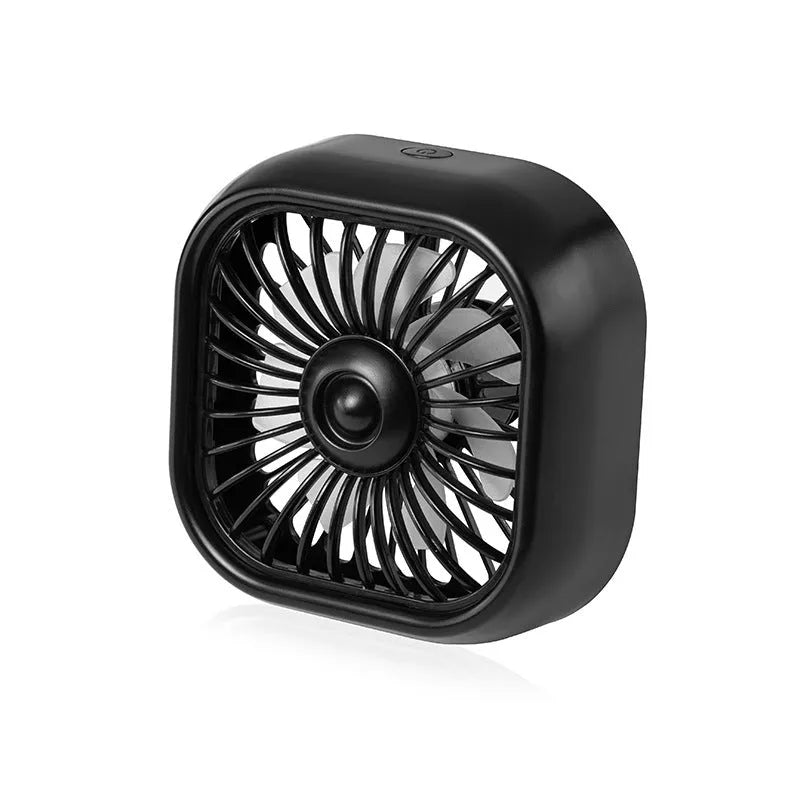 Small black USB fan with keyboard controls for three speed settings on car dashboard