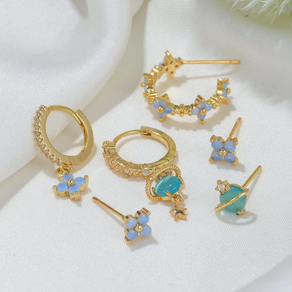 Flower shaped ear studs with blue zircon mosaic in gold and silver colour options