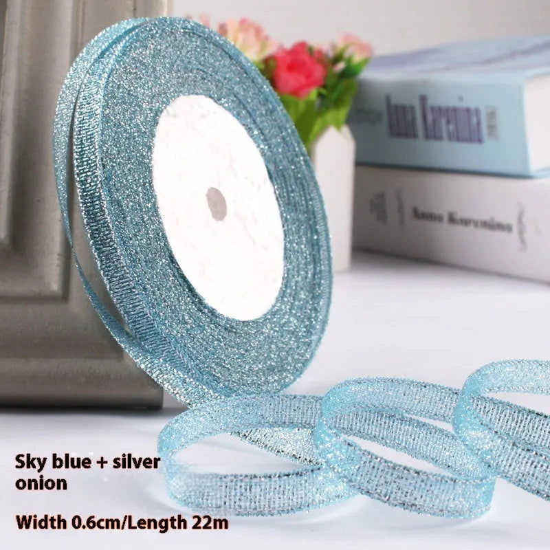 Roll of 0.6cm wide polyester gift ribbon in various colours including gold leaf, coffee and sky blue options