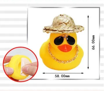 Yellow cartoon Straw Hat Duck car dashboard ornament with matte finish on a car interior.