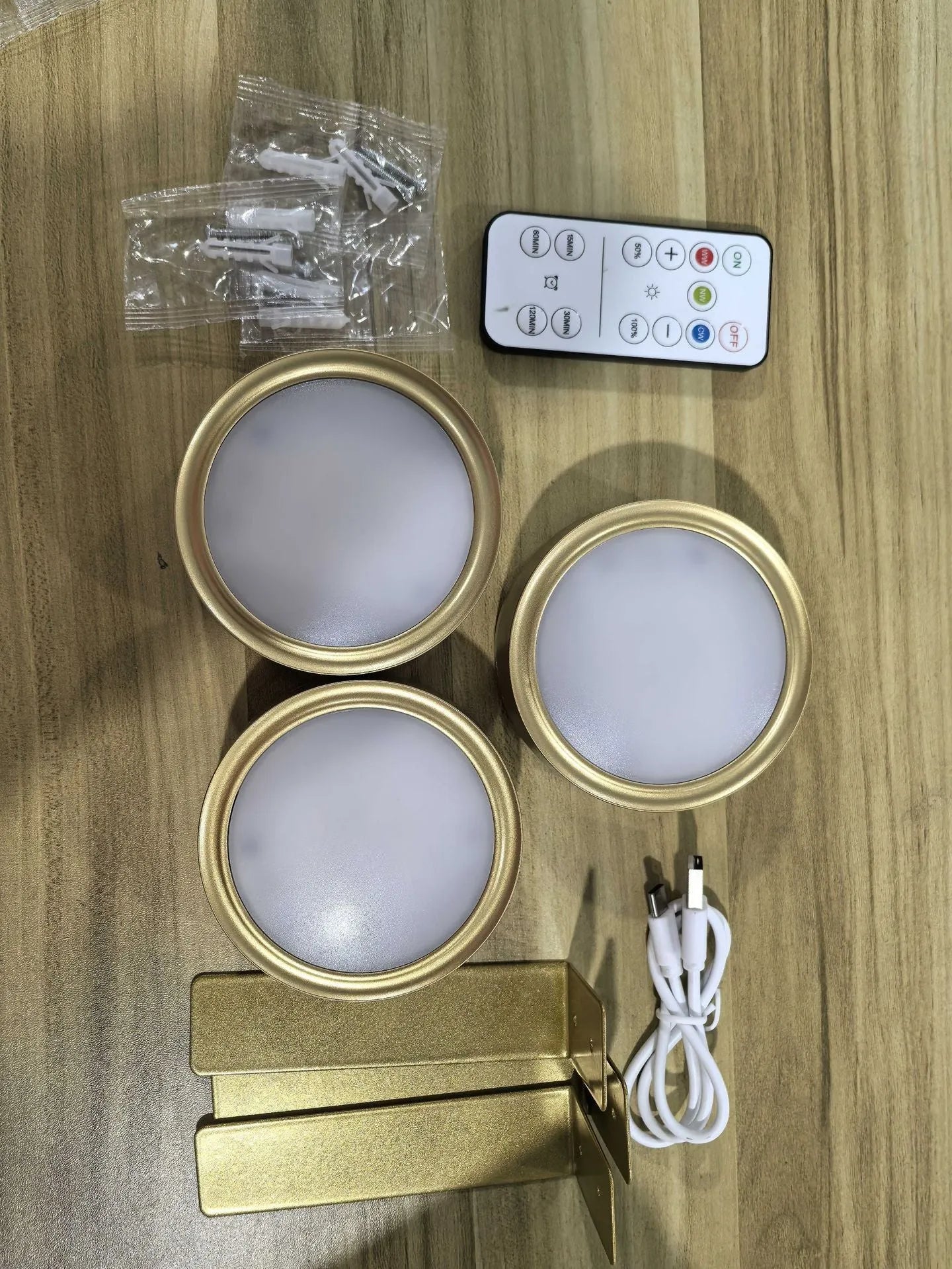 Wireless rechargeable LED painting lamp with magnetic belt attached to a metal frame, remote control nearby.