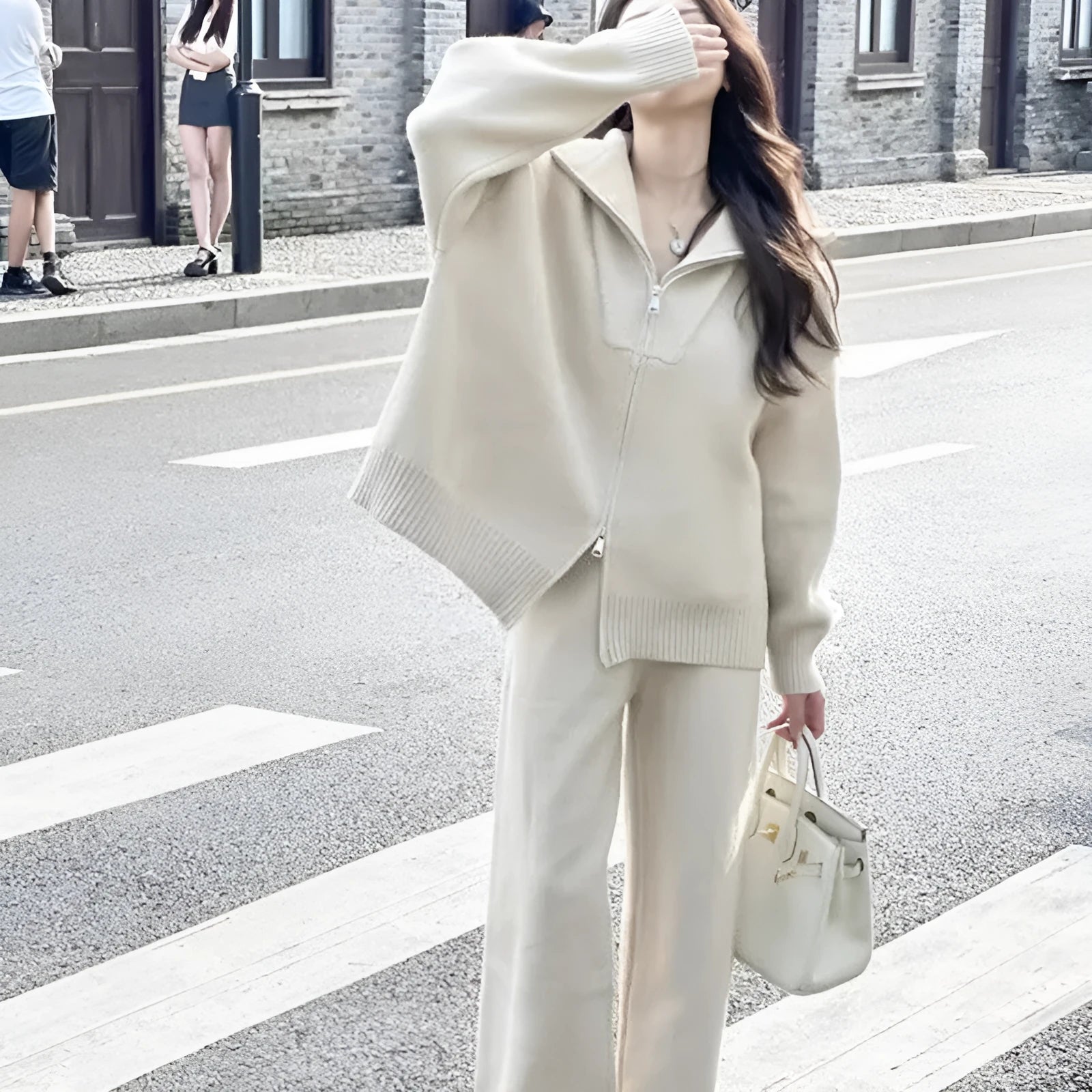 Women's knitted solid colour cardigan and wide leg pants two-piece set in beige.