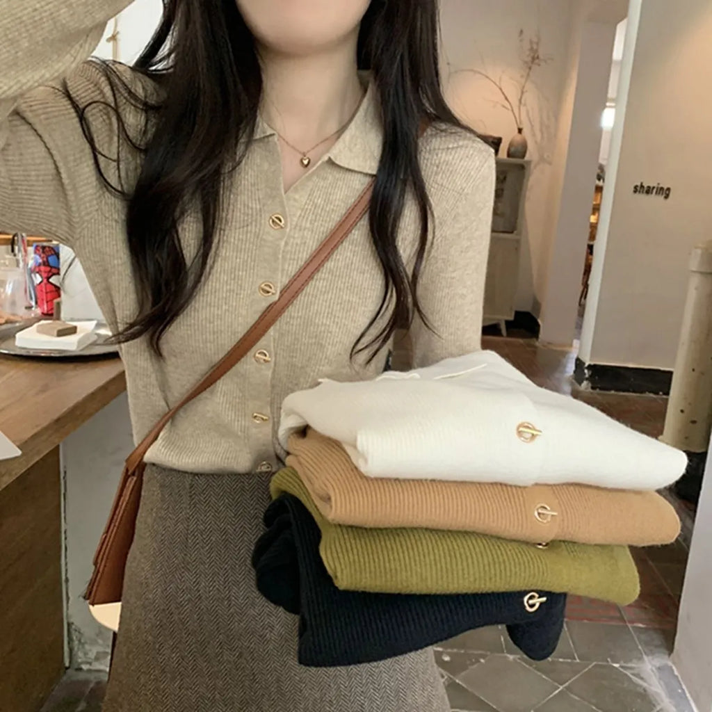 Long-sleeved loose knitted cardigan top in viscose fibre, shown in a neutral colour on a hanger.