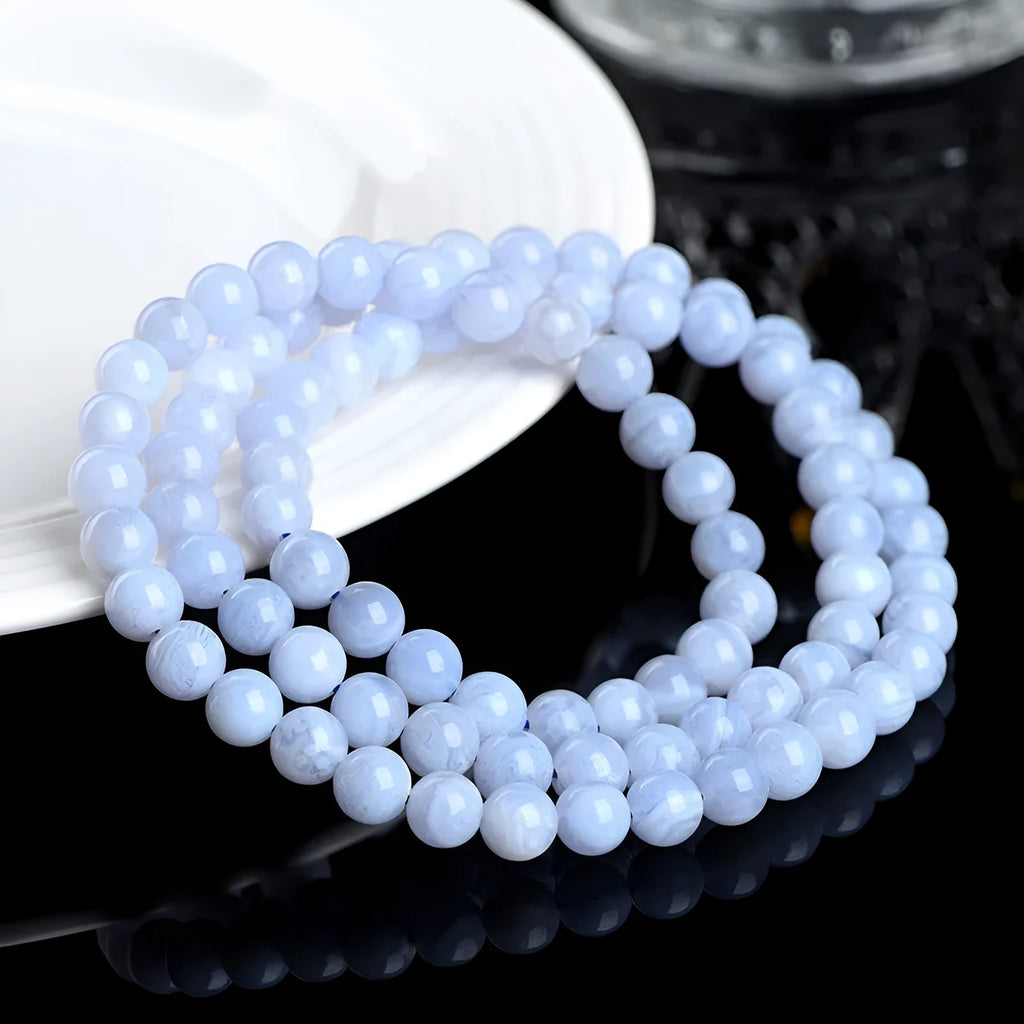 Blue agate bracelet with natural striped patterns, Ruyi design elements, and scattered bead arrangement