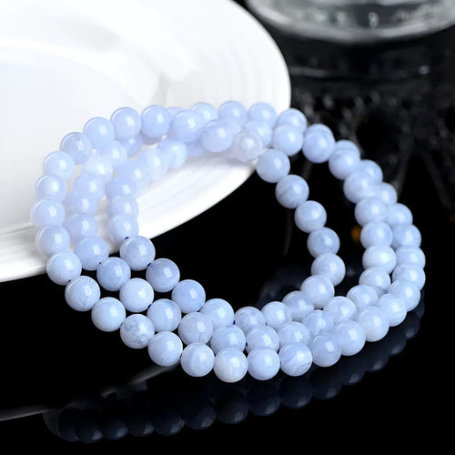 Blue agate bracelet with natural striped patterns, Ruyi design elements, and scattered bead arrangement