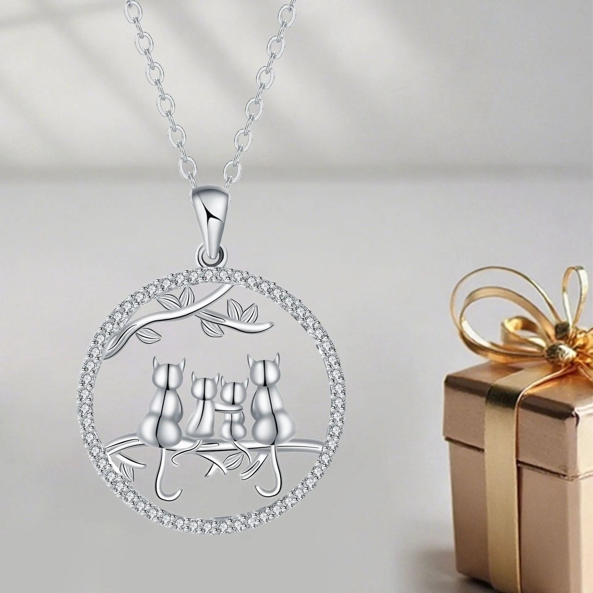 Women's silver-toned necklace with four kitten charms on cross chain