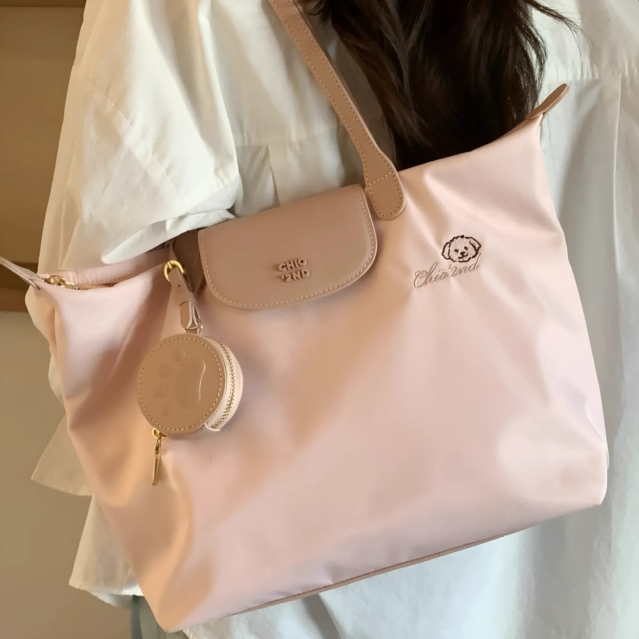 Oxford cloth tote shoulder bag in pink colour with sandwich pocket design and crossbody strap