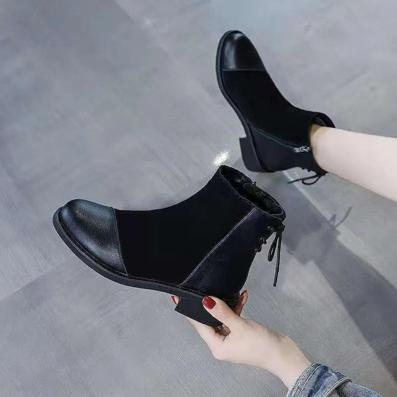 Black women's knee-high Martin boots with side zipper, round toe, and short stout heel.