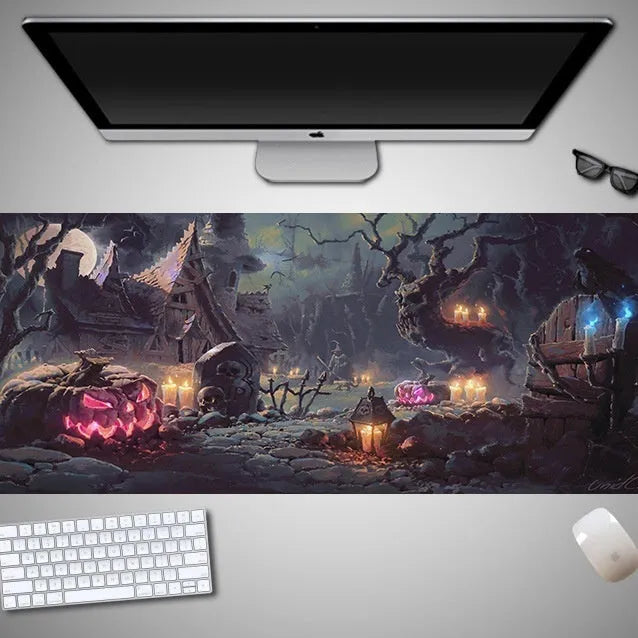 Oversized black Halloween-themed mouse pad with spooky artwork on a desk next to a gaming mouse.