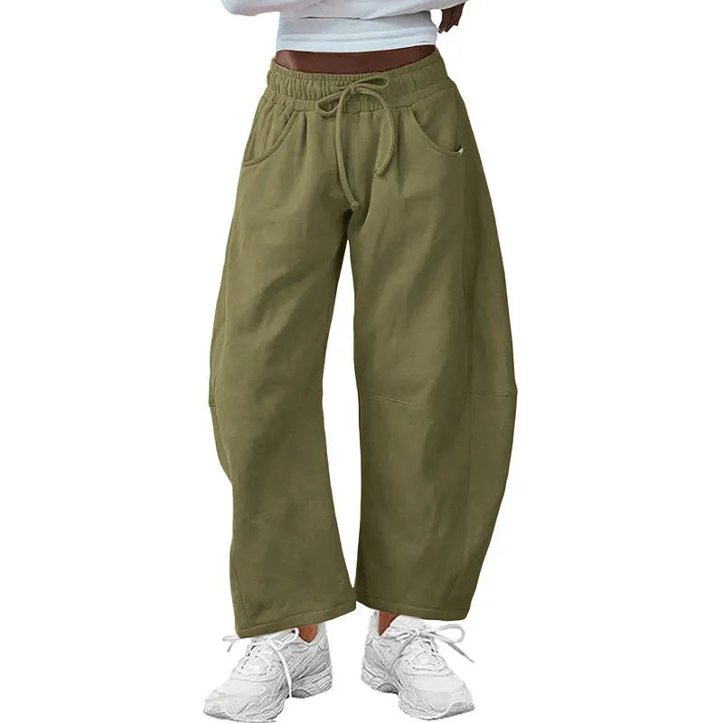 Loose grey cropped sweatpants with elastic drawstring waist and pockets on a mannequin