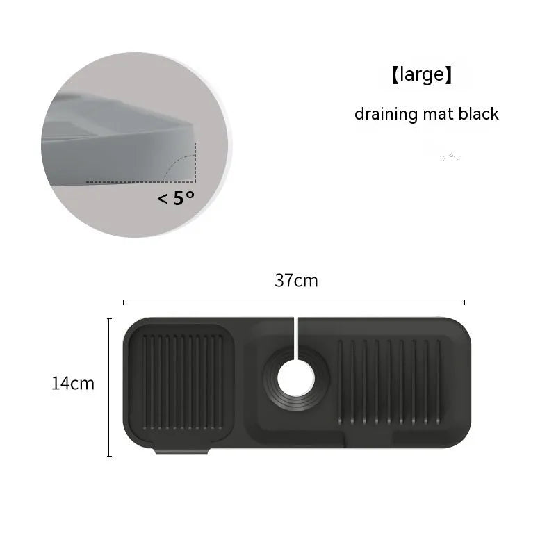 Silicone faucet splash guard pad in sloped design with drain channels on kitchen sink