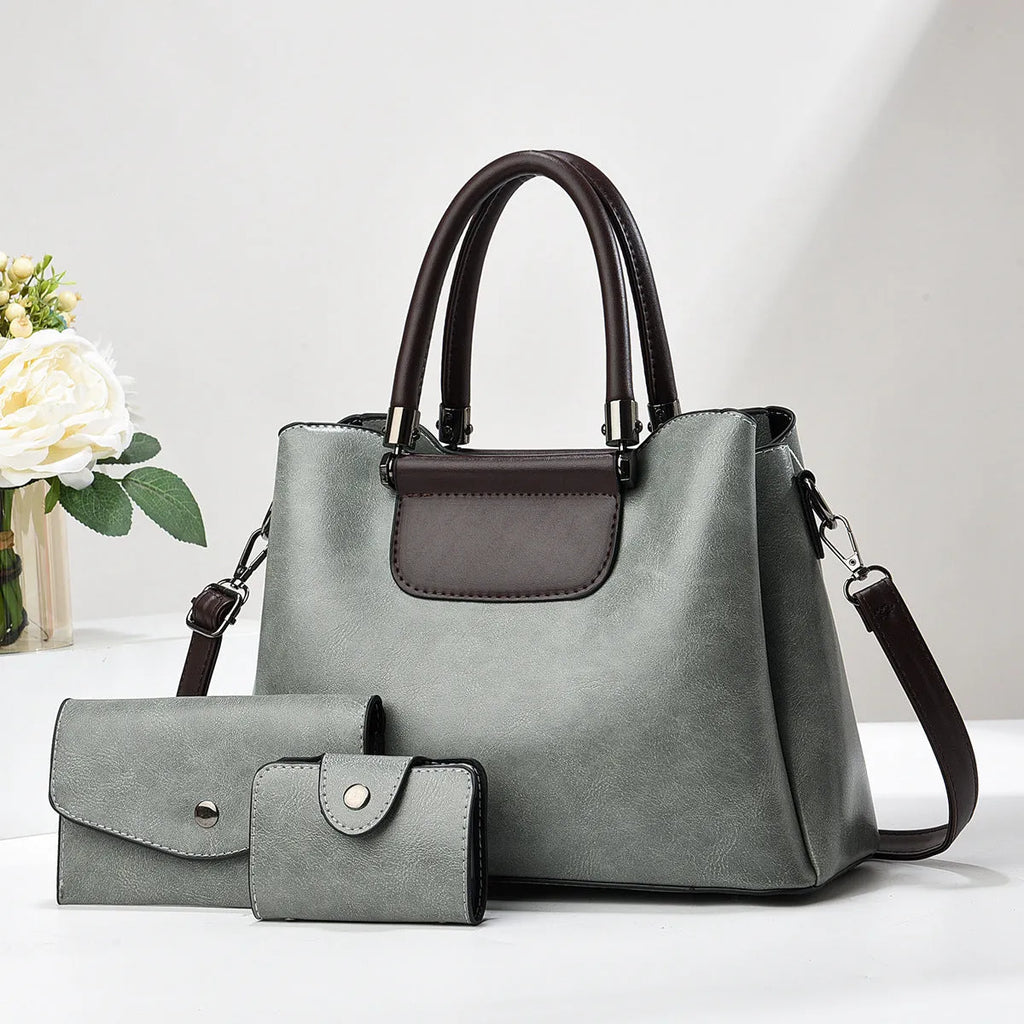Large PU leather handbag set in horizontal square shape with matching medium and small pouches on white background