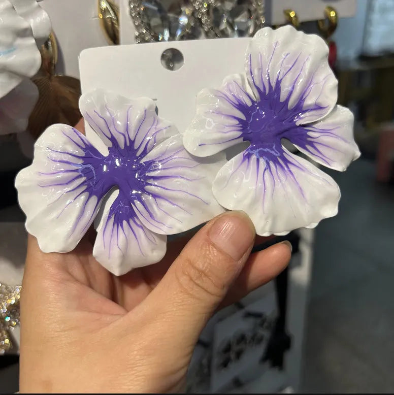 Close-up of pastoral style alloy flower stud earrings with oil-spot glaze in blue, green, purple, and rose colours