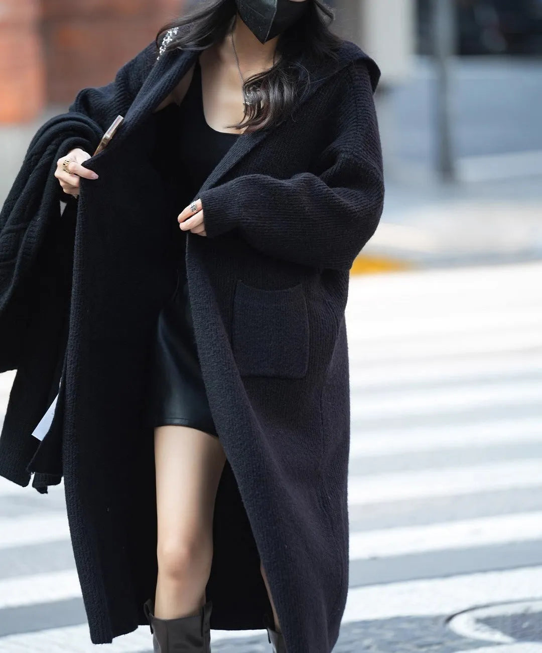 Long grey knitted hooded cardigan trench coat on a hanger, showing loose fit and long sleeves.