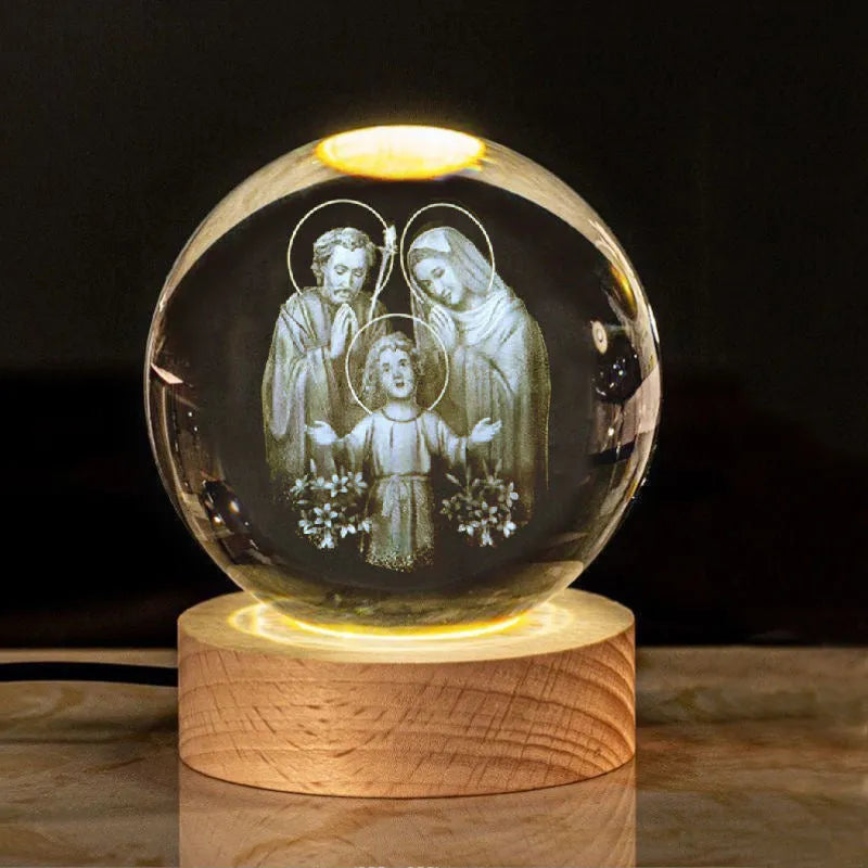 White crystal ball ornament on wood base with warm light and religious symbols