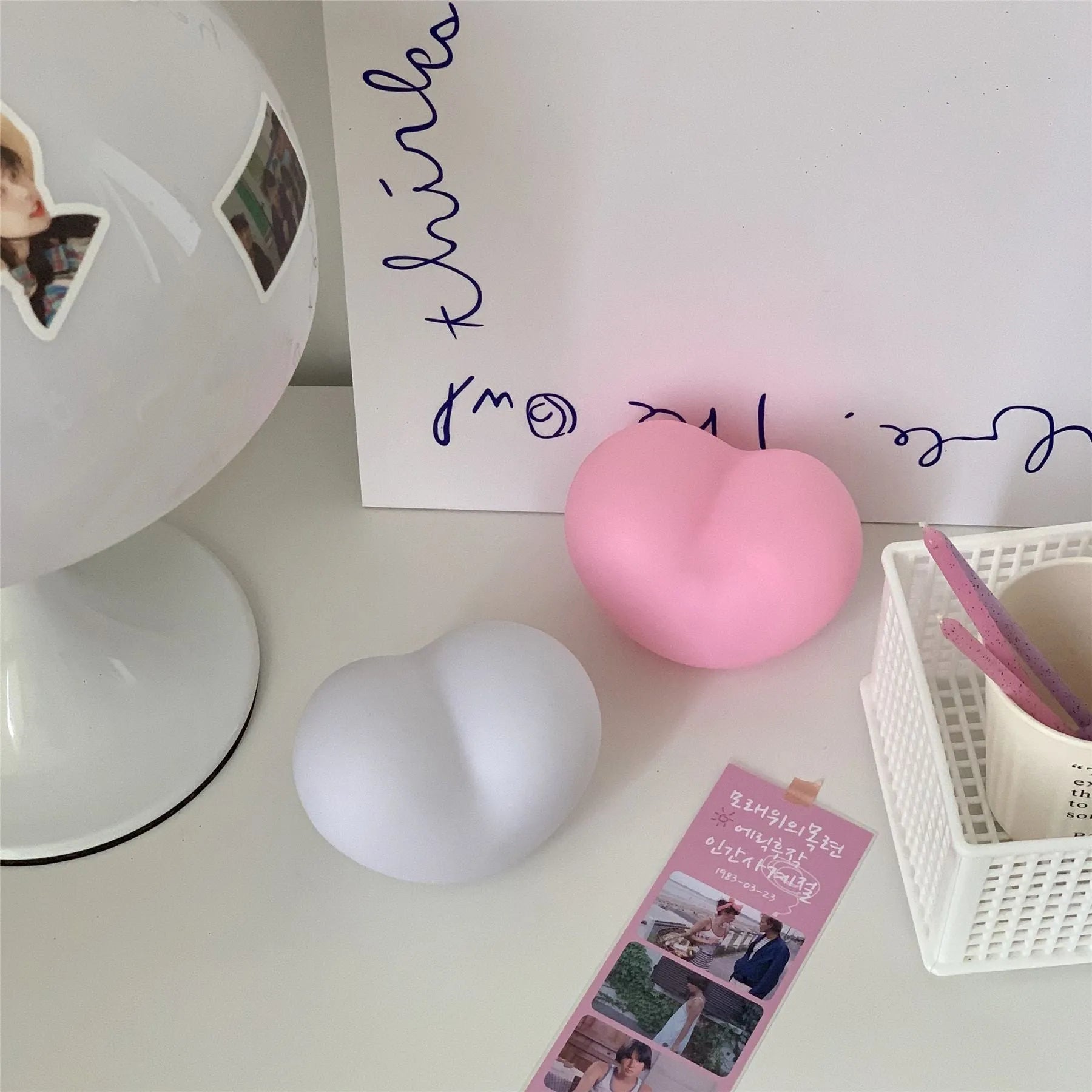 White and pink vinyl atmosphere lamps glowing warmly, shown in small and large size options.