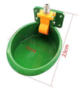 Green plastic drinking bowl for sheep and pigs on a farm.