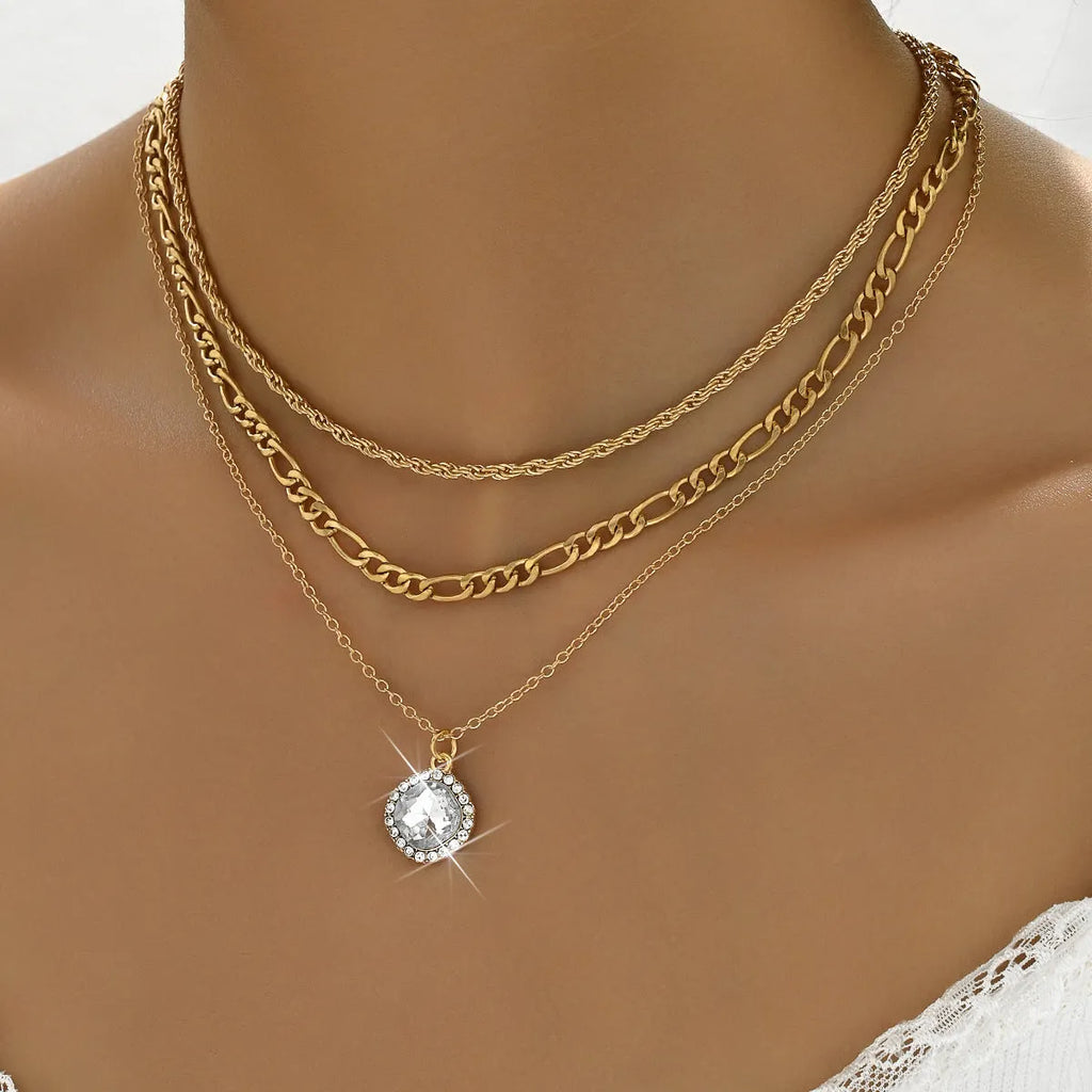 Gold multi-layer pendant necklace with large hemp flowers chain and geometric round pendant on woman