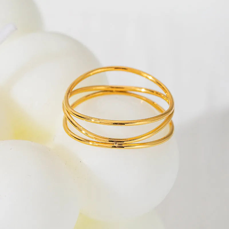 Gold geometric line ring with three-layer coil design on titanium steel band