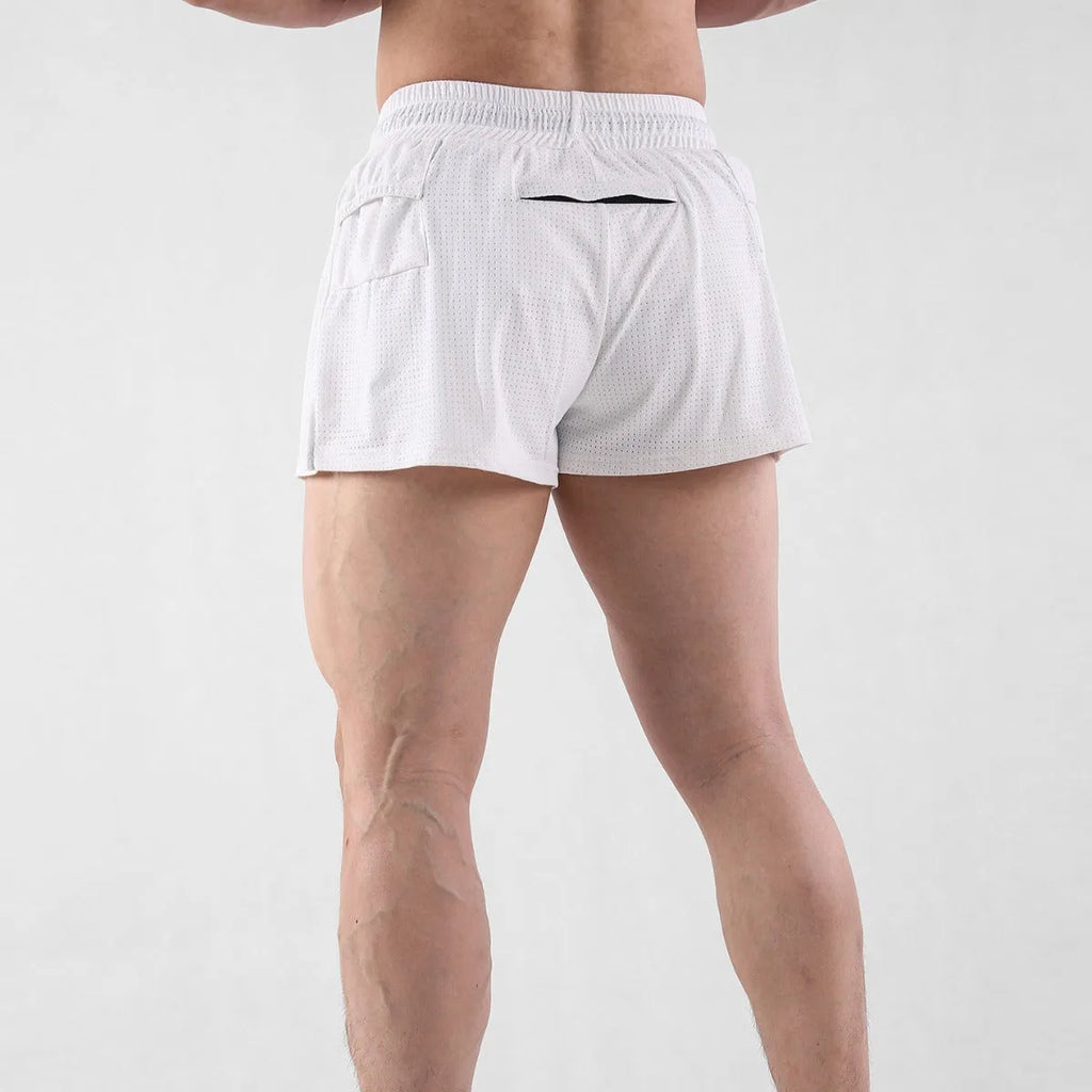 Men's white and black quick-drying nylon sports shorts on a size chart background.