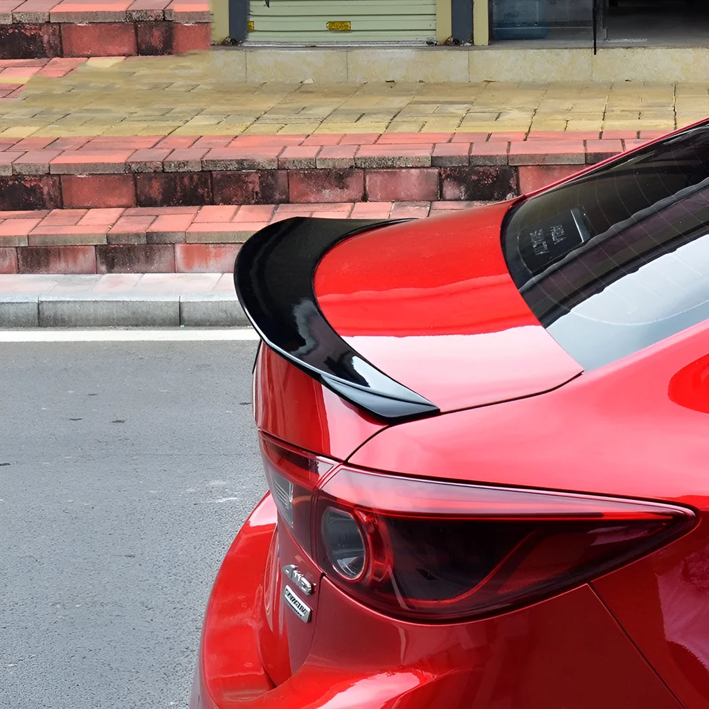 Bright black Mazda 3 Axela Exela tail trim for 2014-2021 models showing large fixed wind surrounded blade design