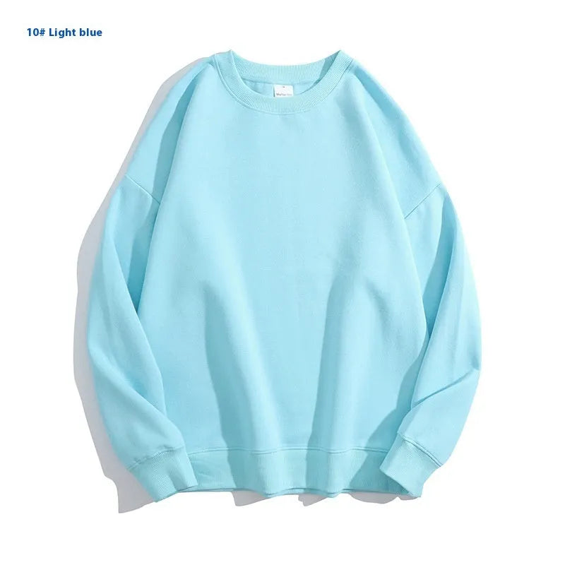 A loose-fitting, off-shoulder cotton sweater in a solid colour with long sleeves and a round neck.
